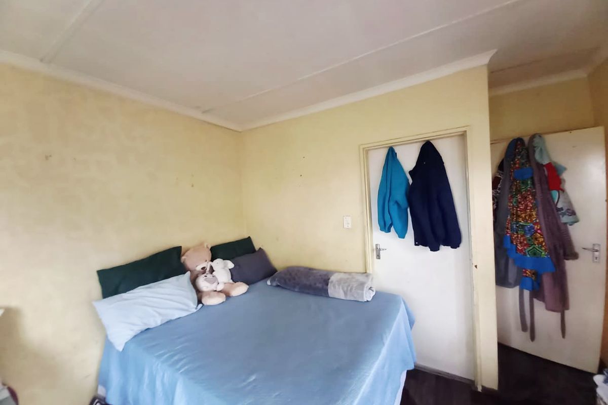 A bedroom featuring standard interior doors and basic wall finishes, providing a functional space for rest.