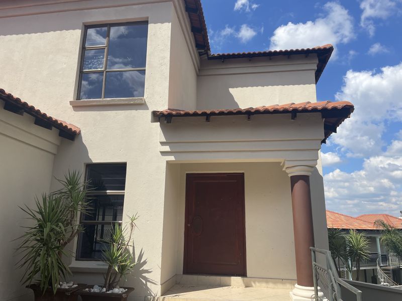 Front entrance elevation featuring a covered porch with a decorative column, terracotta roof tiles, and a solid timber entrance door.