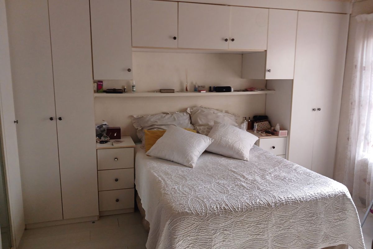 A bedroom featuring extensive built-in cabinetry, overhead storage, and integrated bedside tables, providing ample storage space within a functional layout.