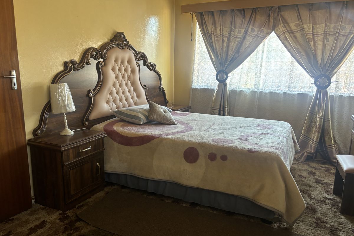 A bedroom featuring dated carpet flooring and yellow wall finishes, offering potential for modernization and aesthetic updates.