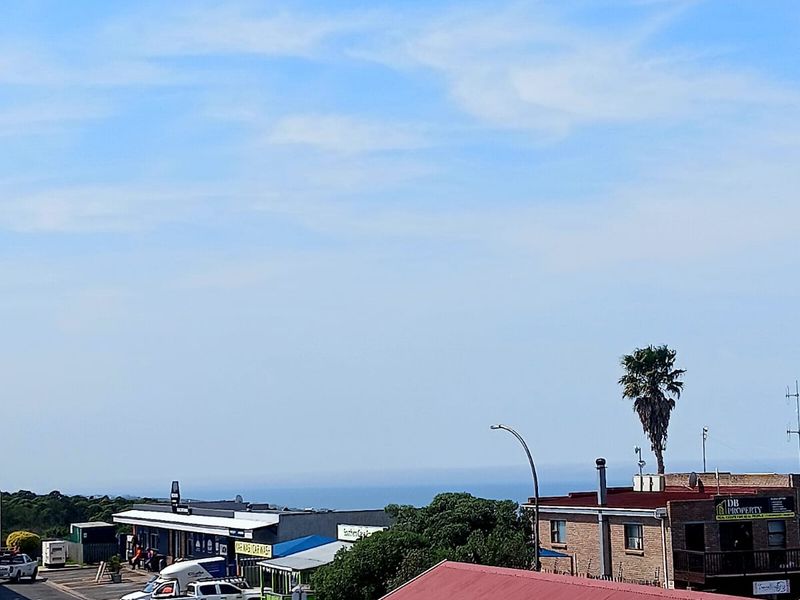 An elevated view overlooking the surrounding neighborhood, local commercial buildings, and distant horizon.