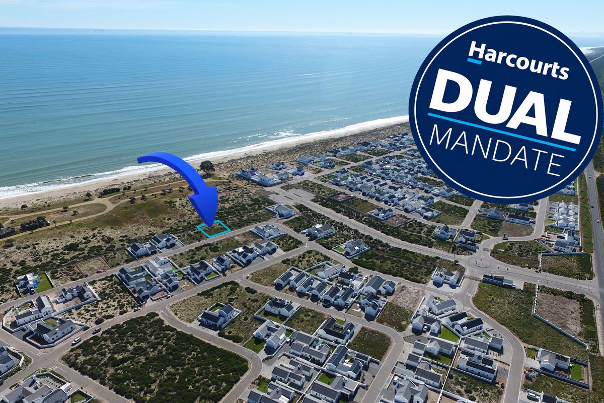 Aerial view of a vacant residential plot situated in a coastal estate, offering proximity to the beach and surrounding residential infrastructure.