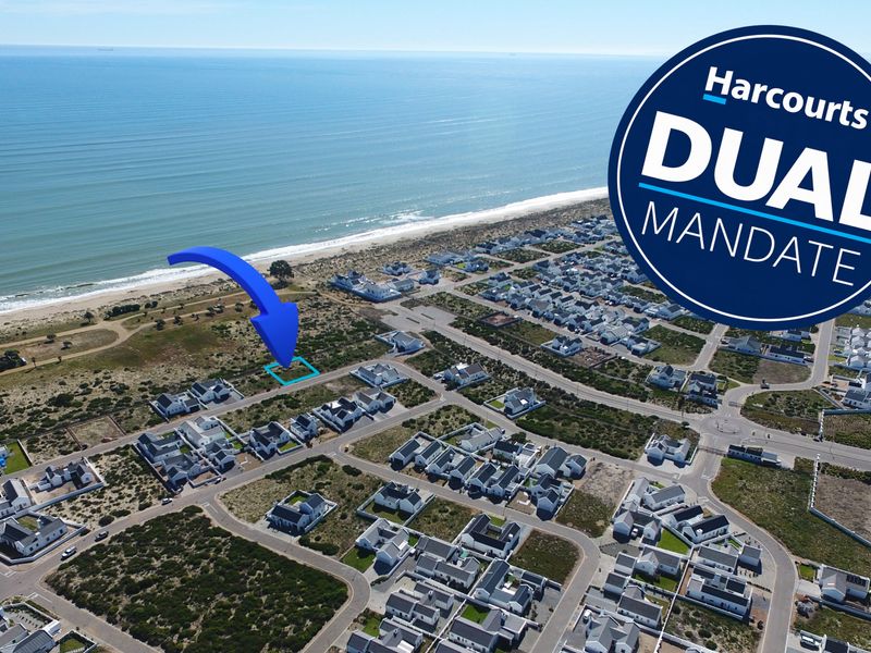 Aerial view of a vacant residential plot situated in a coastal estate, offering proximity to the beach and surrounding residential infrastructure.