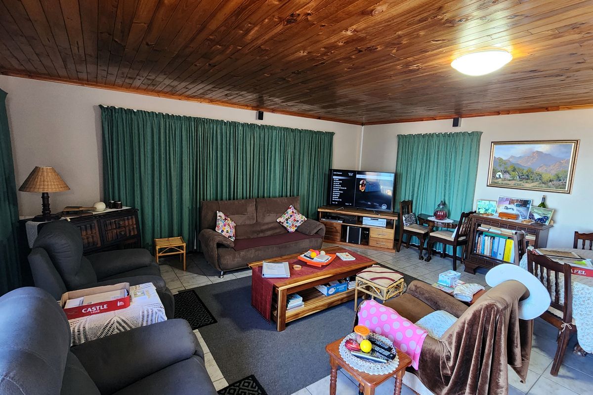 Spacious living area featuring a warm timber tongue and groove ceiling and tiled flooring, offering a comfortable and functional layout.
