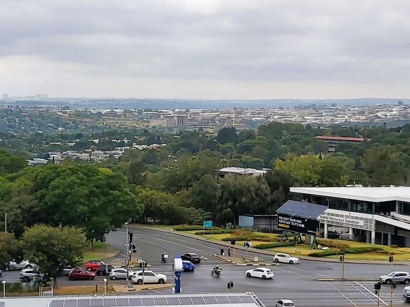 Elevated panoramic view overlooking the surrounding urban landscape, main roads, and local commercial infrastructure.