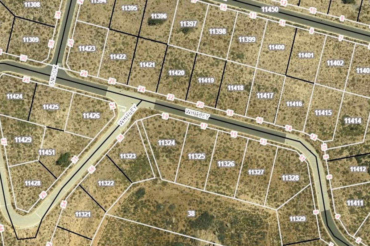 An aerial cadastral map showing the layout and boundaries of residential plots, with lot 11312 highlighted in blue.