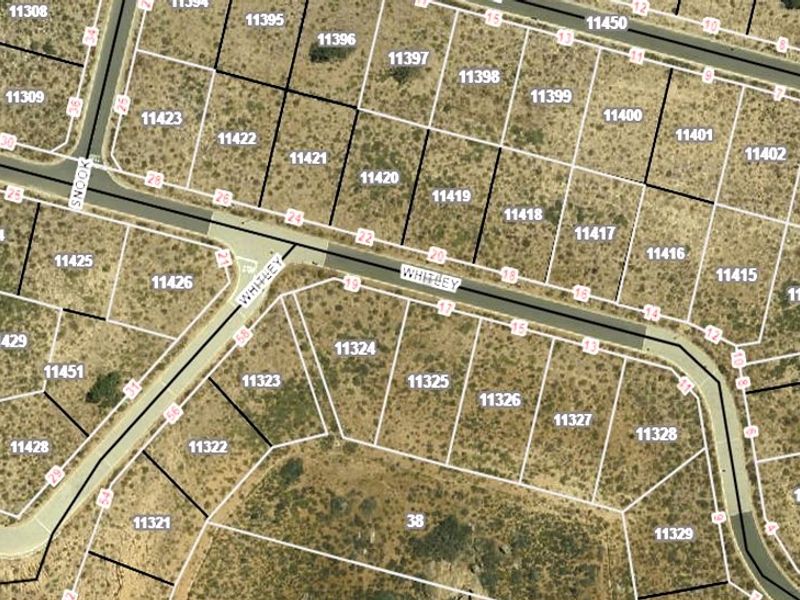 An aerial cadastral map showing the layout and boundaries of residential plots, with lot 11312 highlighted in blue.