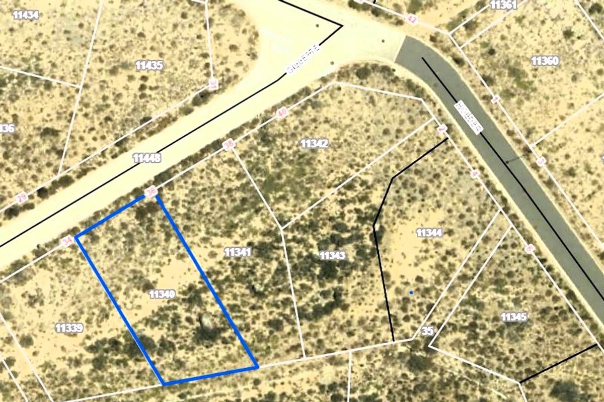 An aerial view showing the boundaries and location of the vacant residential land plot within the surrounding neighborhood.