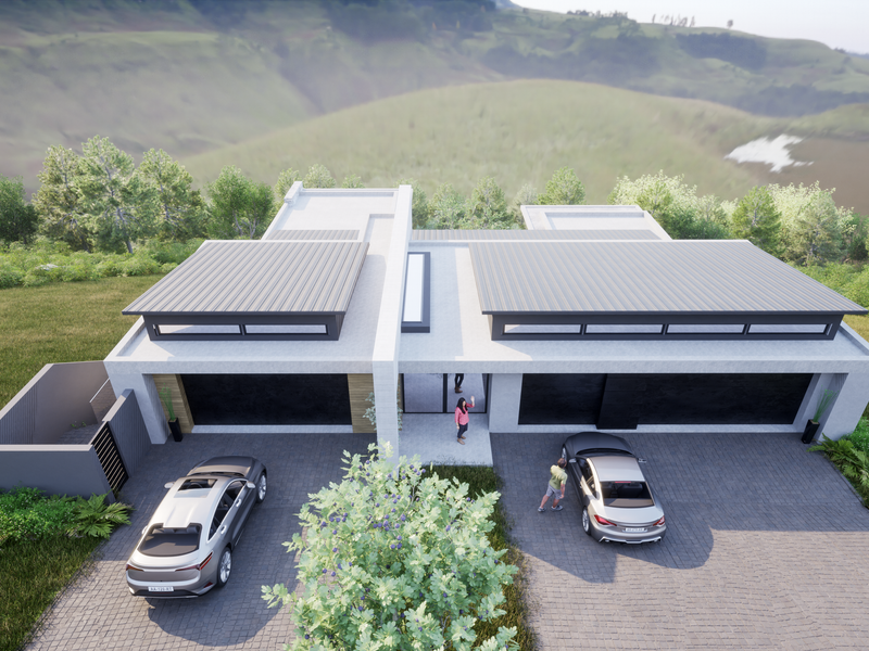 An aerial view of a modern residential property featuring a sleek metal roof, paved driveway, and contemporary architectural design set in a scenic landscape.