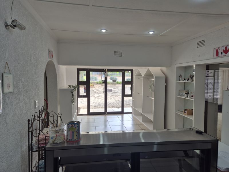 Entrance area featuring tiled flooring, recessed lighting, and built-in shelving, providing a functional reception or display space with direct access to the exterior.