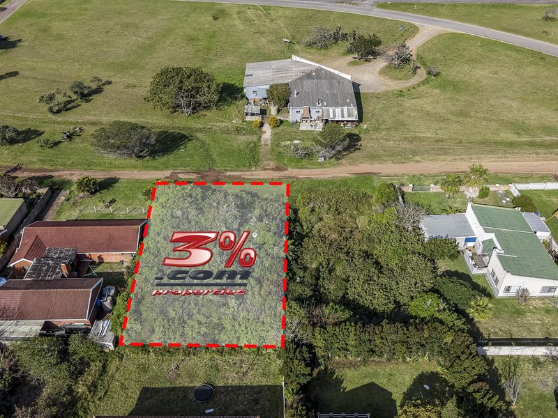 An aerial view of a vacant residential plot highlighted with boundary markers, situated in an established neighborhood.