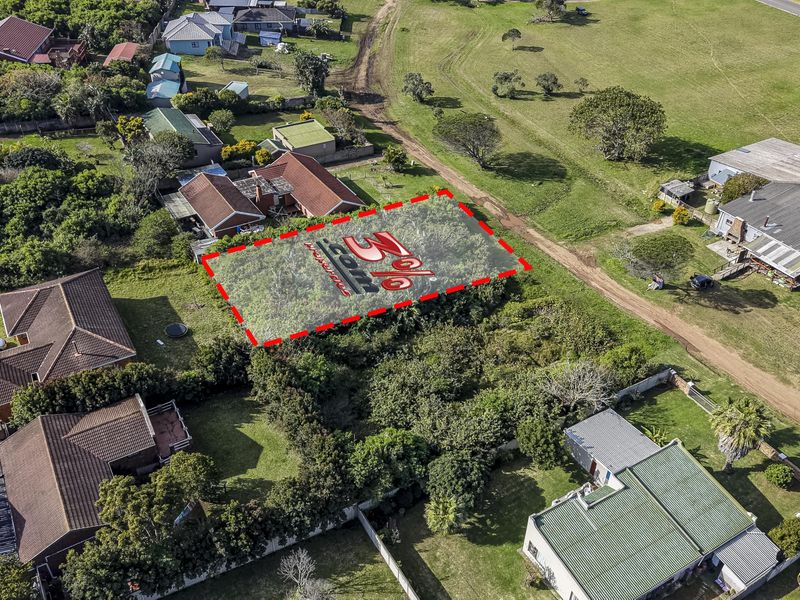 Aerial view of a vacant residential plot featuring natural vegetation, situated within an established neighborhood.