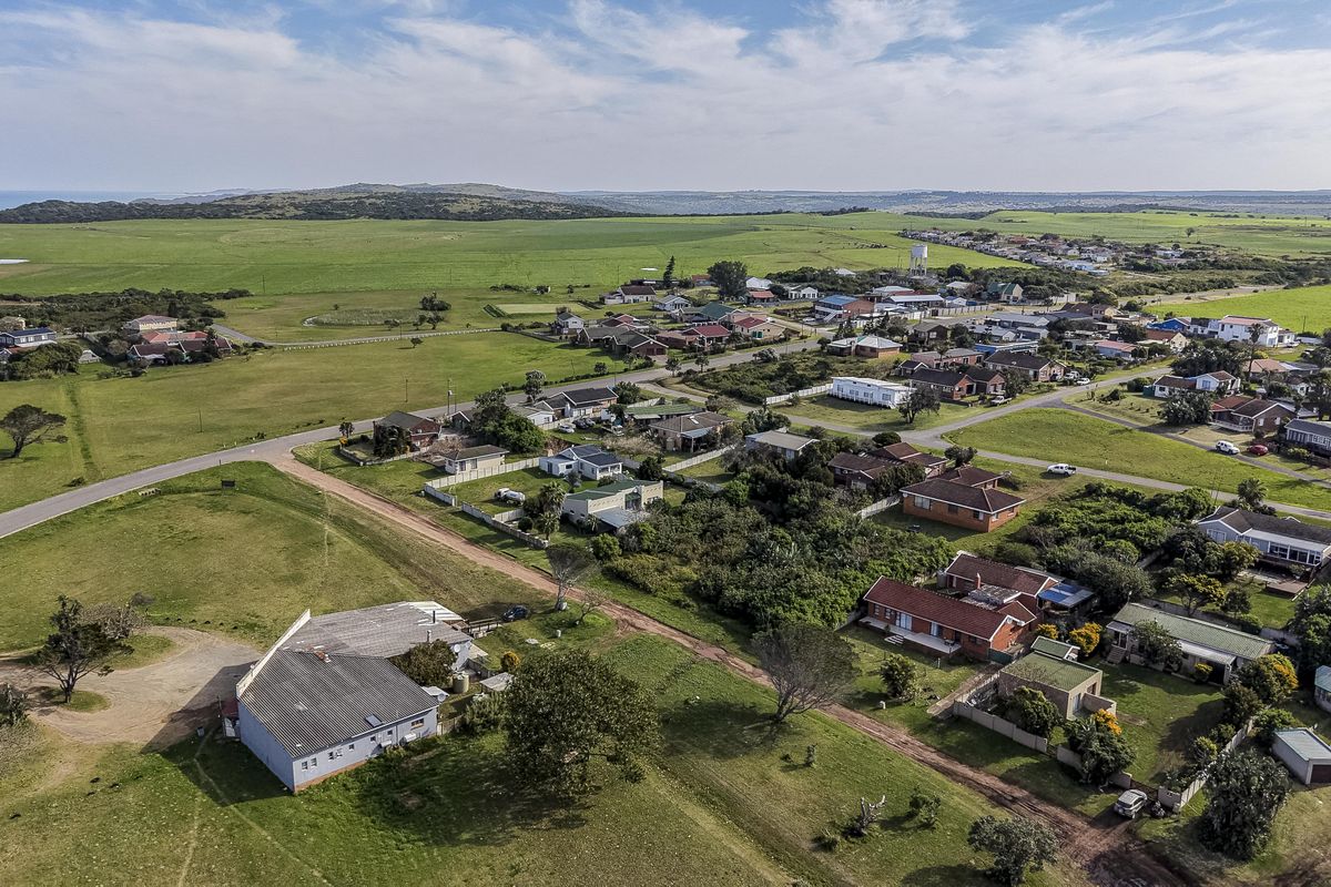 An aerial view of the residential area and surrounding landscape, showcasing the property's location within the neighborhood and proximity to the coast.