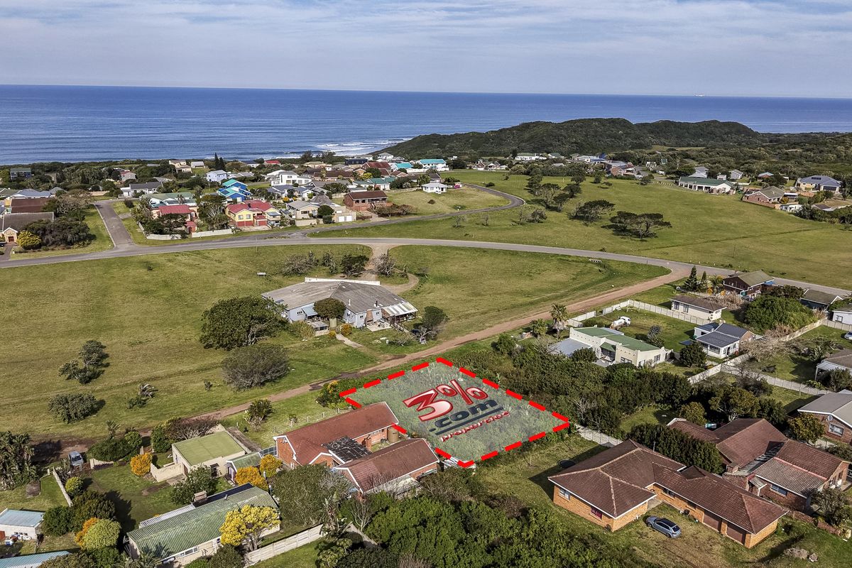 Aerial view of a vacant residential land plot situated in a coastal neighborhood, highlighting the property boundaries and surrounding landscape.