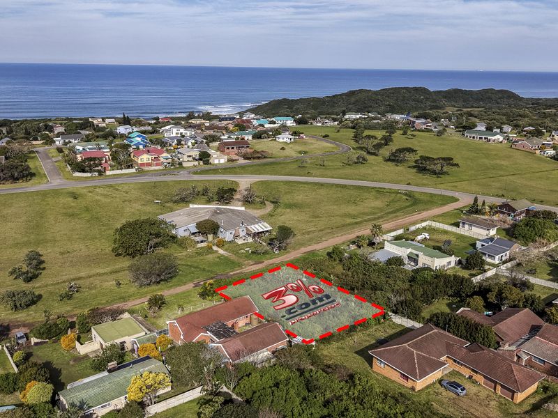 Aerial view of a vacant residential land plot situated in a coastal neighborhood, highlighting the property boundaries and surrounding landscape.