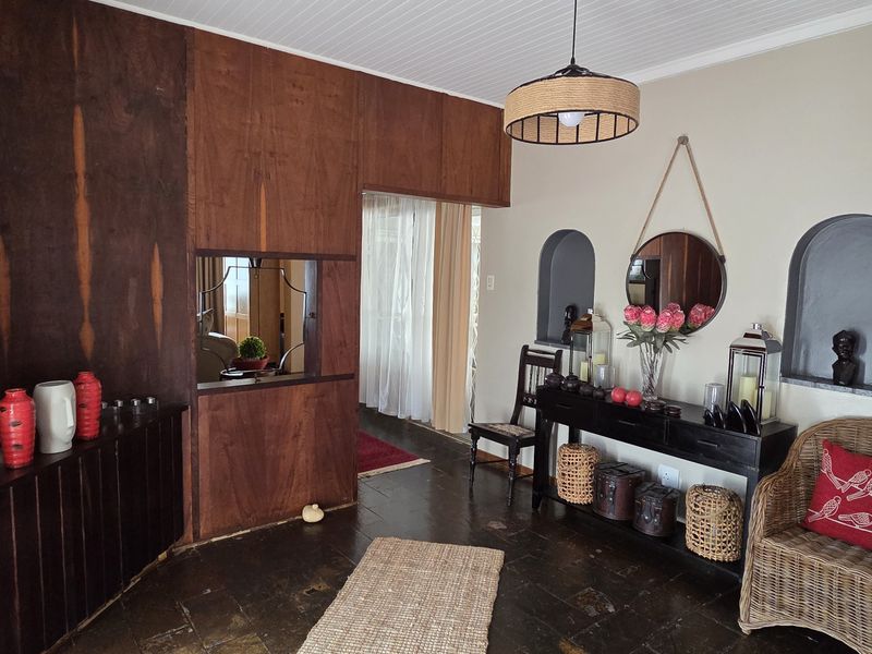 A living area featuring dark stone flooring, built-in wooden cabinetry, and decorative arched wall niches, creating a warm and traditional atmosphere.