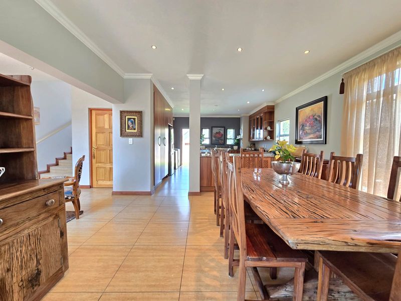 Spacious open-plan living and dining area featuring tiled flooring, recessed lighting, and a seamless transition into the kitchen space.