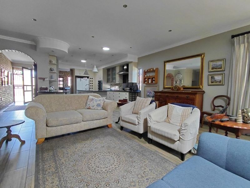 Spacious open-plan living area featuring tiled flooring, recessed lighting, and a seamless transition into the kitchen space.