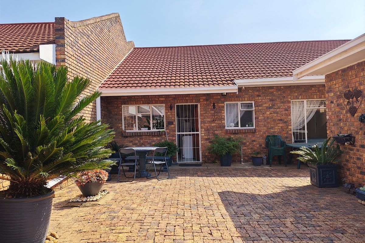 A private rear courtyard featuring durable brick paving, facebrick exterior walls, and a pitched tiled roof, providing a low-maintenance outdoor living space.