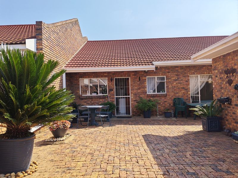 A private rear courtyard featuring durable brick paving, facebrick exterior walls, and a pitched tiled roof, providing a low-maintenance outdoor living space.