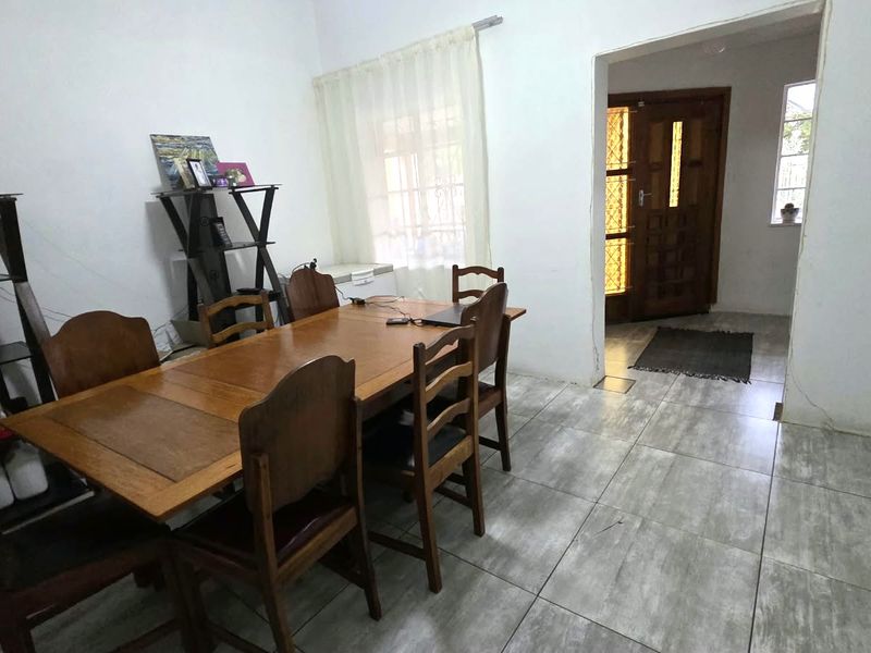 Dining room featuring tiled flooring and direct access to the main entrance area with a timber front door.