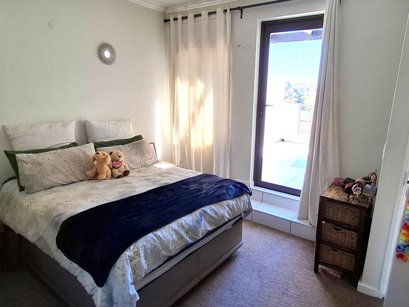 A bedroom featuring carpeted flooring and a glass sliding door providing access to an outdoor area.