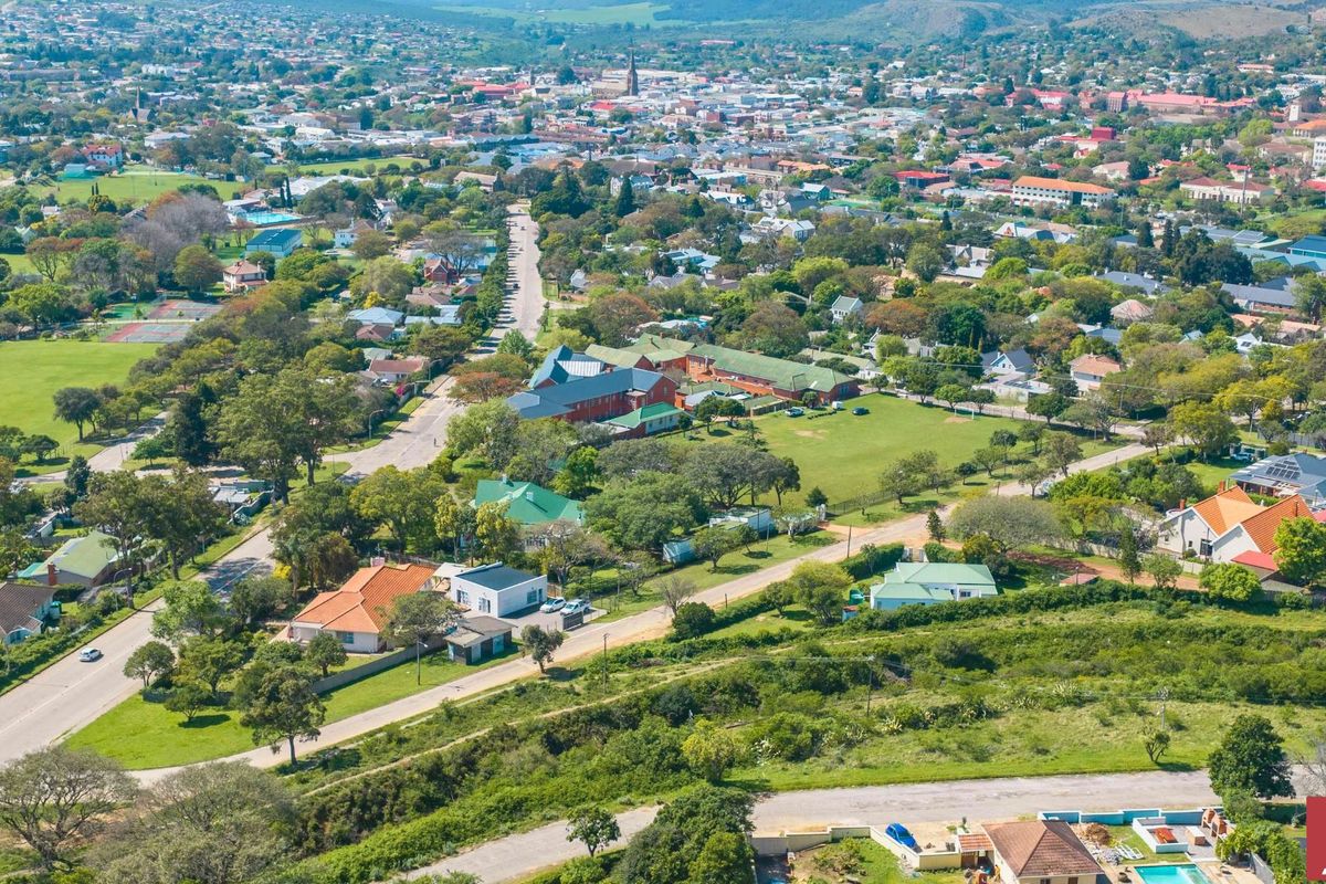 An elevated aerial view showcasing the surrounding residential neighborhood, local infrastructure, and green spaces within the community.
