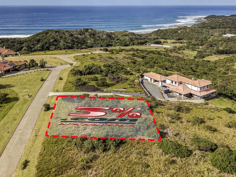 Aerial view of a vacant residential plot situated in a coastal estate with surrounding natural vegetation and nearby ocean views.