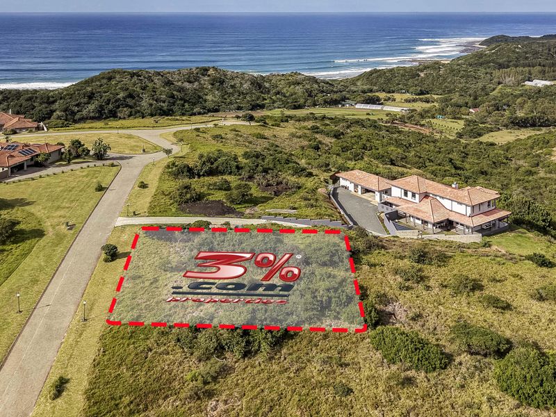 An aerial view of a vacant residential plot situated in a coastal estate, featuring surrounding natural vegetation and proximity to the ocean.
