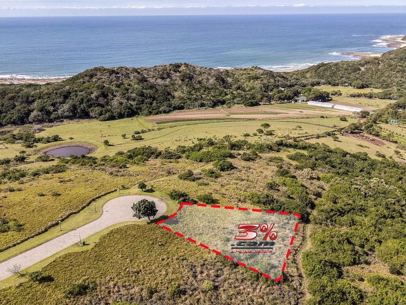 Aerial view of a vacant residential plot featuring coastal landscape views and direct access to a paved road.