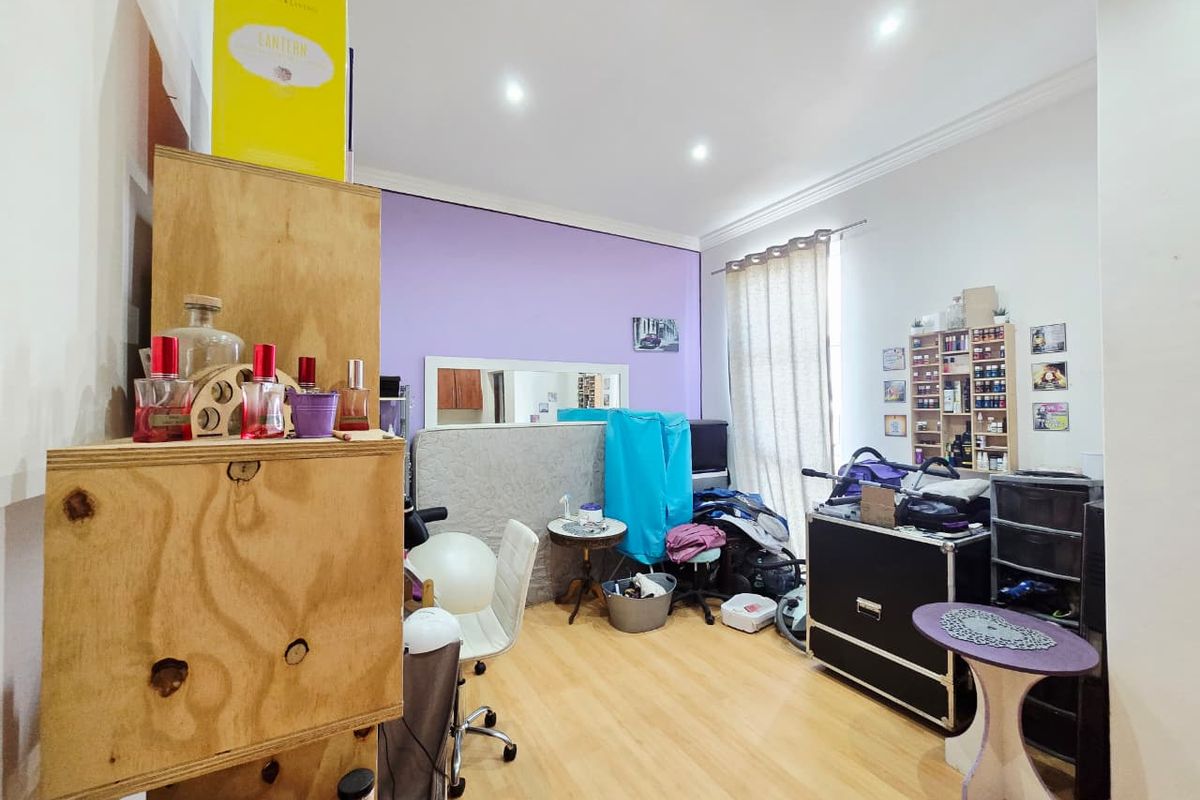 A bedroom featuring laminate flooring and recessed downlighting, currently utilized as a multi-purpose space.
