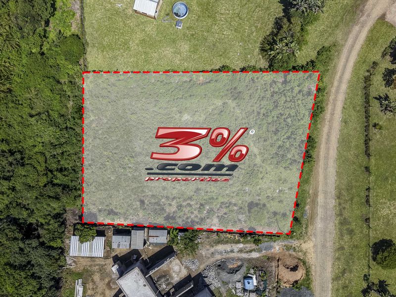 Aerial view of a vacant residential plot featuring natural vegetation and surrounding landscape, ideal for future development.