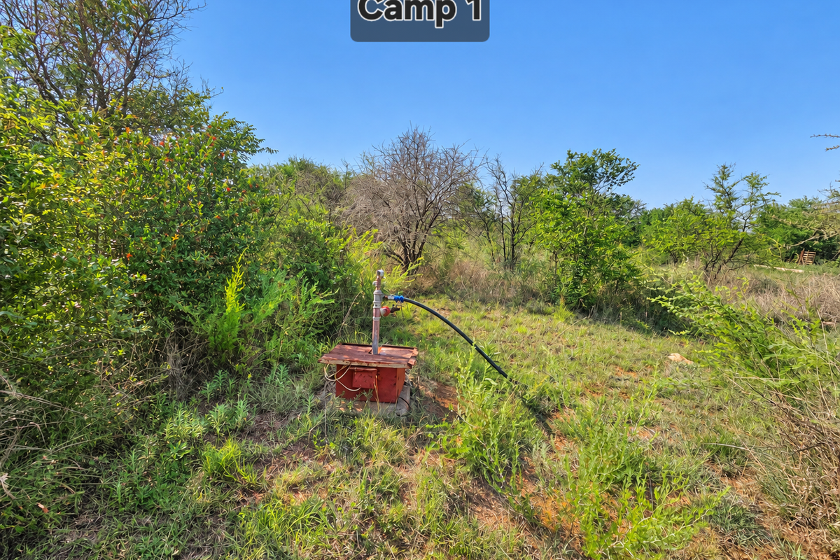 A functional borehole pump installation located within the farm grounds, providing essential water infrastructure for the property.