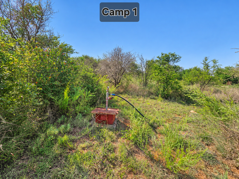A functional borehole pump installation located within the farm grounds, providing essential water infrastructure for the property.