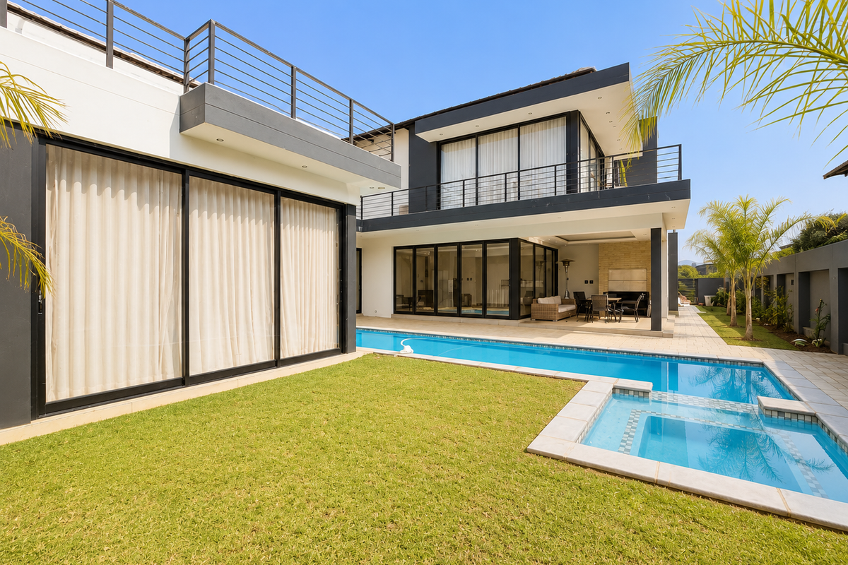 Modern double-story residence featuring a swimming pool, integrated spa, expansive sliding glass doors, and a spacious patio area perfect for outdoor entertaining.