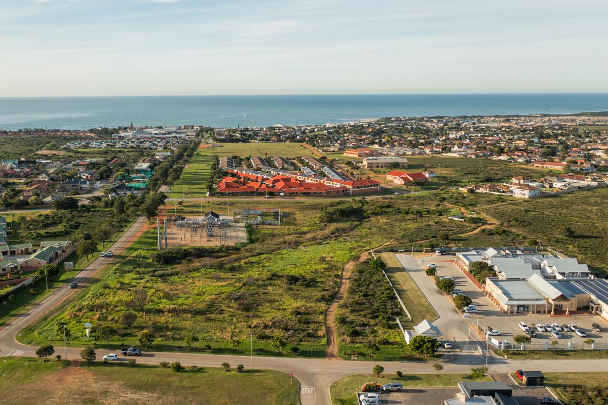 An aerial view of the vacant residential land, showcasing the surrounding neighborhood, local infrastructure, and proximity to the coastline.