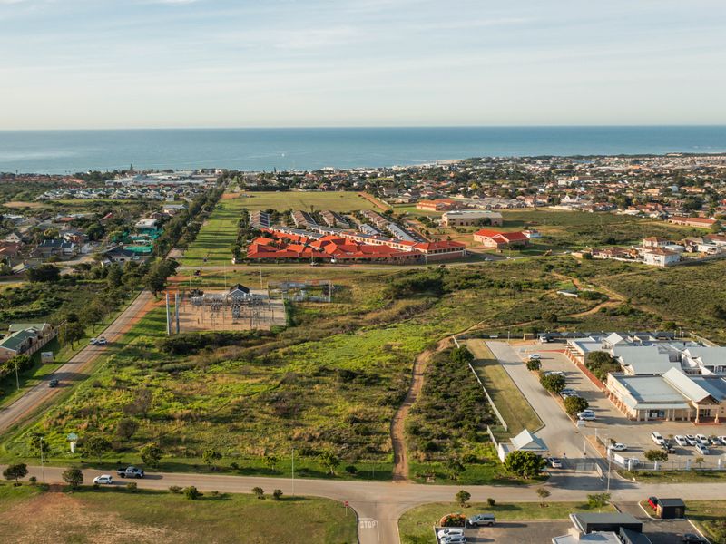 An aerial view of the vacant residential land, showcasing the surrounding neighborhood, local infrastructure, and proximity to the coastline.