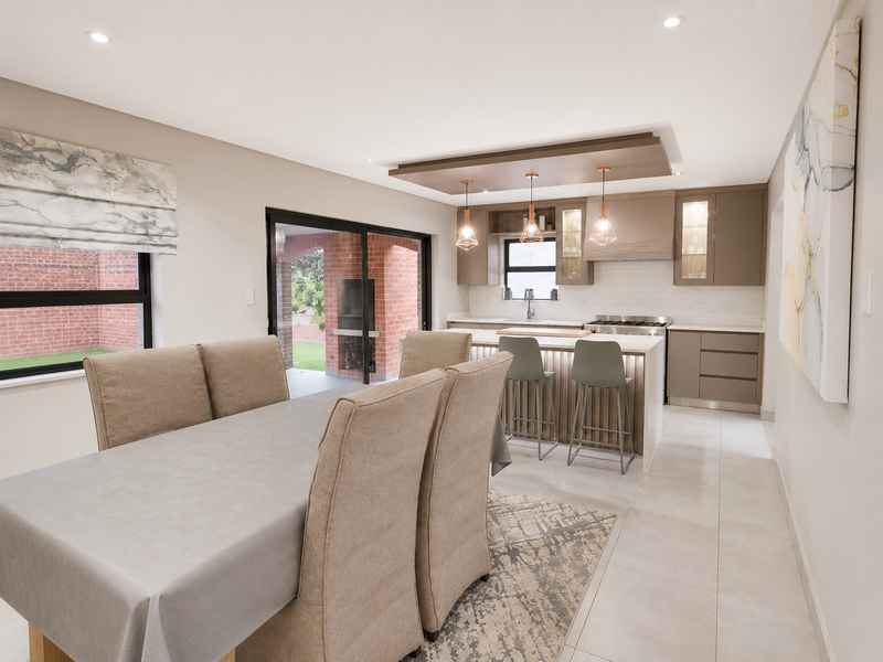 Modern open-plan kitchen and dining area featuring a central island, sleek cabinetry, high-end appliances, and seamless access to the outdoor patio.