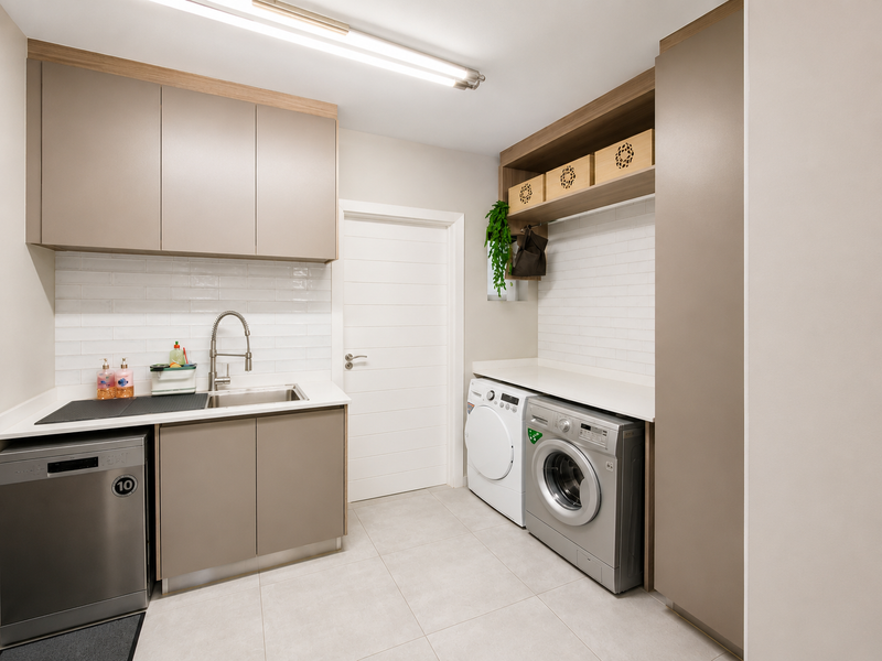 A modern, well-appointed laundry room featuring sleek built-in cabinetry, quartz countertops, subway tile backsplash, and dedicated space for laundry appliances.