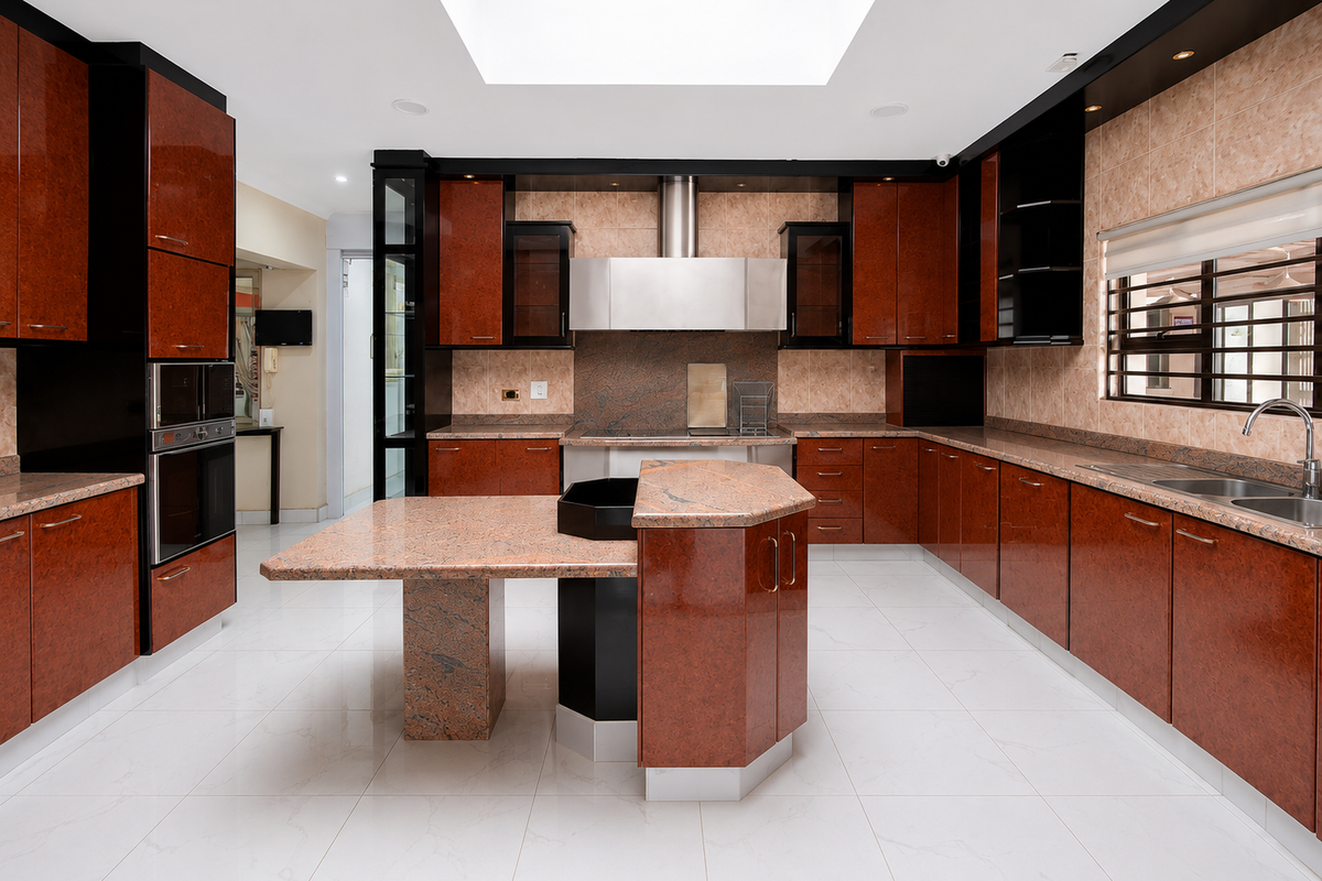 Spacious kitchen featuring high-gloss cabinetry, granite countertops, a central island, built-in appliances, and a large skylight providing ample natural light.