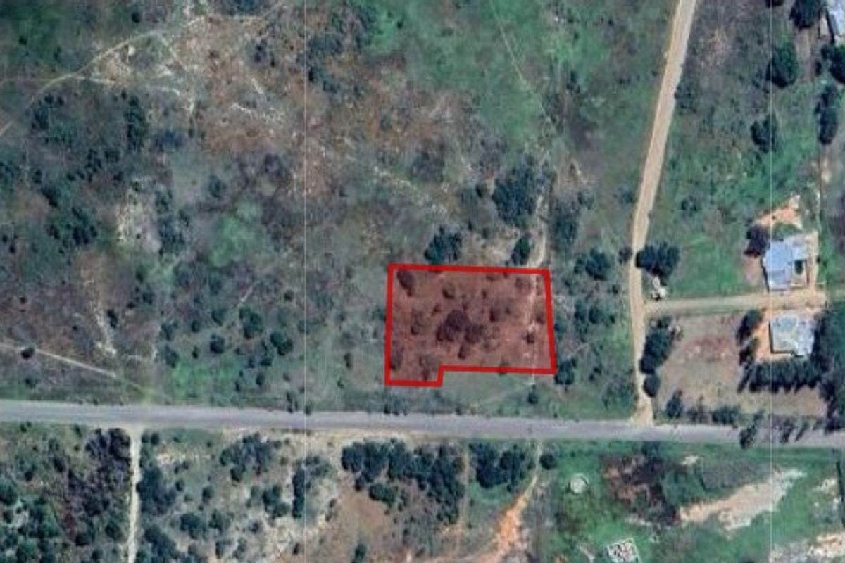 An aerial view of a vacant residential plot of land, showing its location and boundaries relative to the surrounding area.