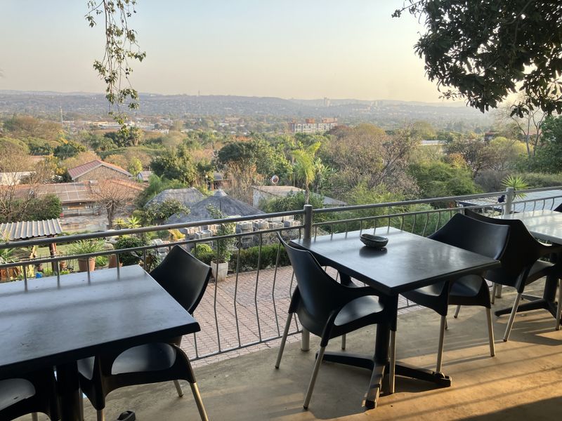 Elevated balcony area featuring a metal balustrade and expansive views over the surrounding landscape and neighborhood.