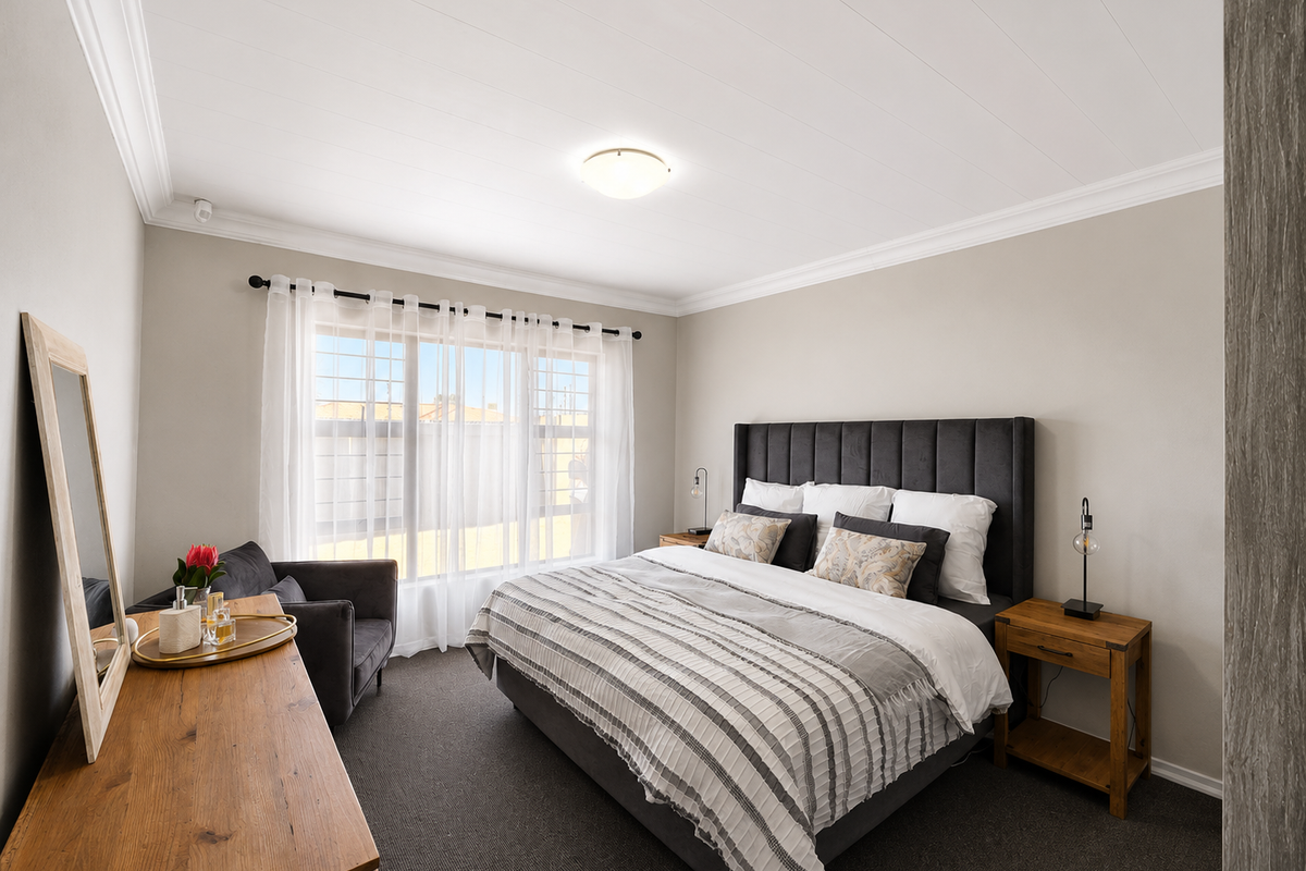 A well-maintained bedroom featuring neutral wall tones, carpeted flooring, decorative ceiling cornicing, and a large window with security bars.