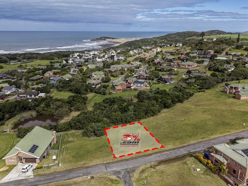 Aerial view of a vacant residential plot situated in a coastal estate, offering proximity to the ocean and surrounding established neighborhood.