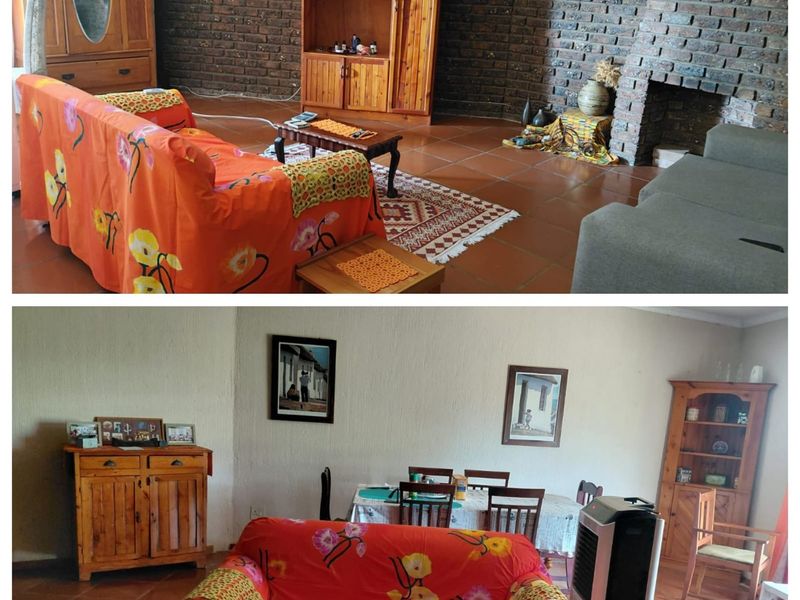 A living room featuring a rustic brick fireplace and terracotta floor tiles, offering a traditional aesthetic with potential for modern updates.