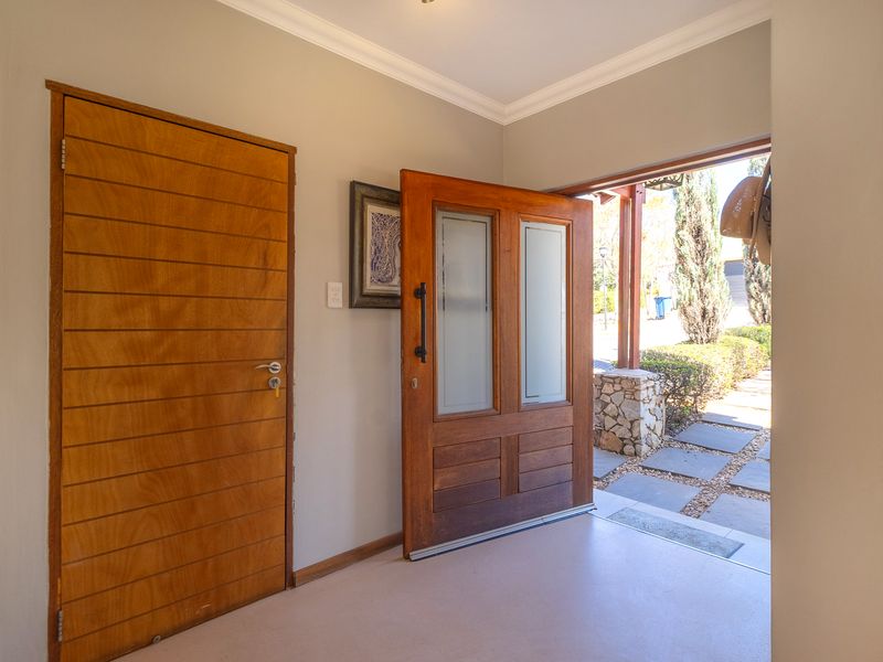 Bright and welcoming entrance foyer featuring a solid timber front door with glass inserts and a secondary internal timber door.