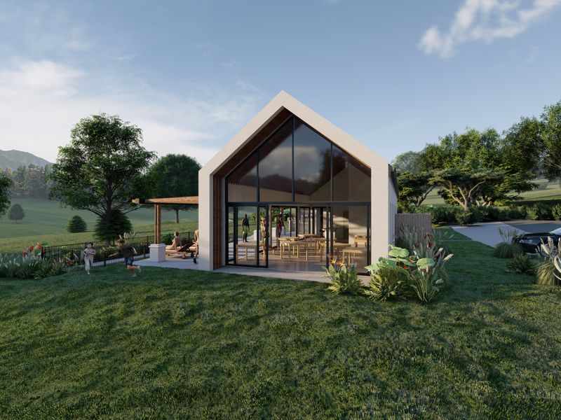 A modern gabled residential structure featuring a large glass facade, covered patio area, and landscaped surroundings in a scenic setting.
