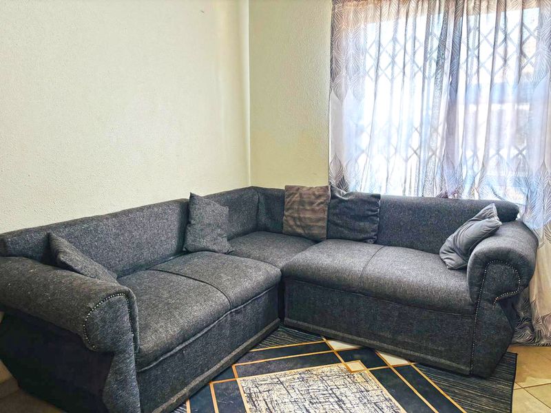 A living room area featuring a window with a fitted security gate and neutral wall finishes.