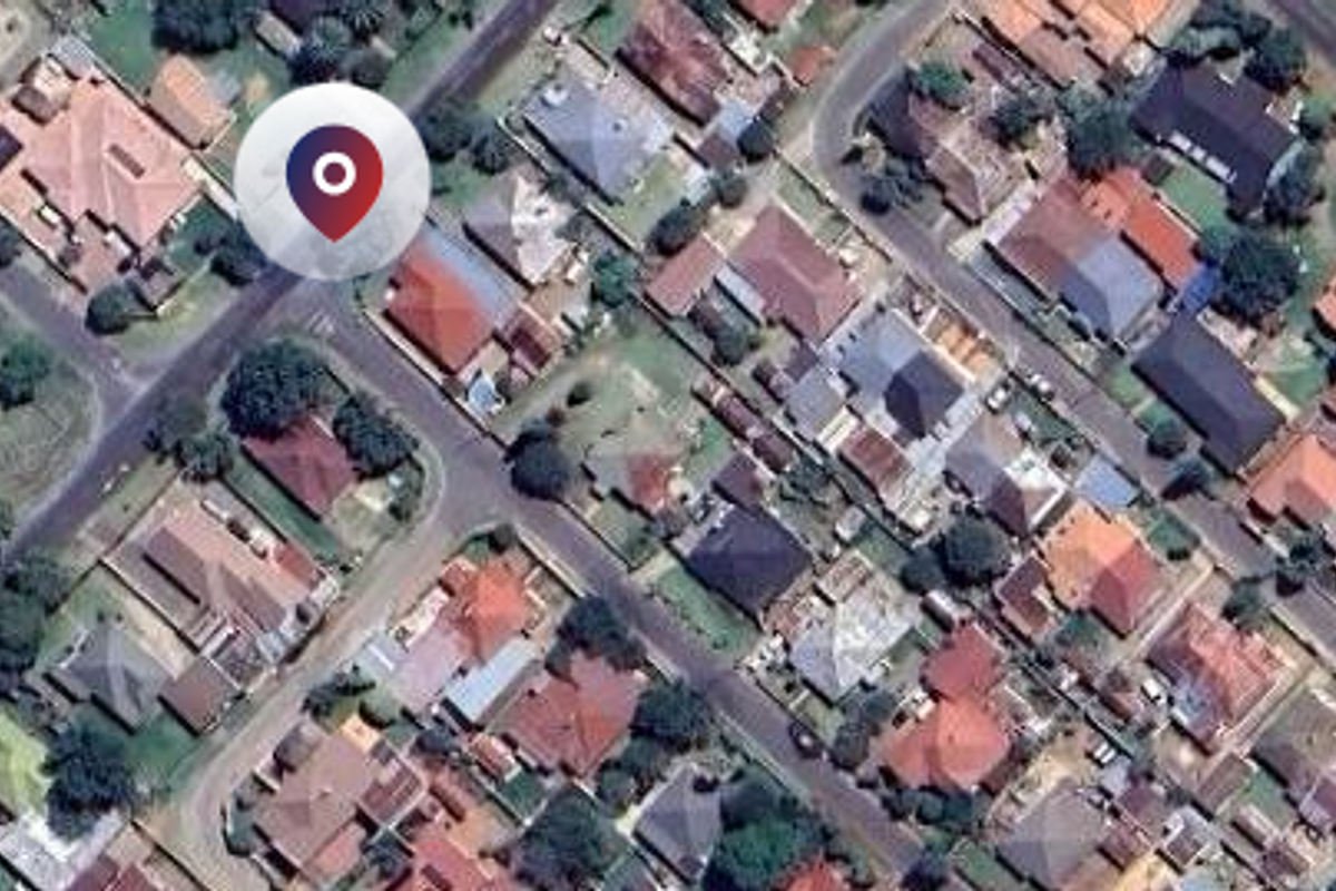 An aerial view of a residential neighborhood showing the layout of houses, streets, and surrounding properties.