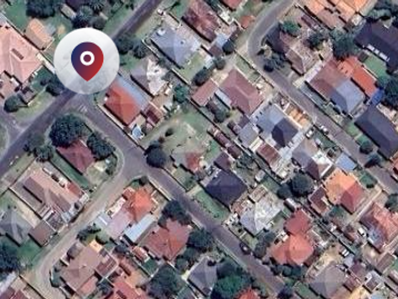 An aerial view of a residential neighborhood showing the layout of houses, streets, and surrounding properties.